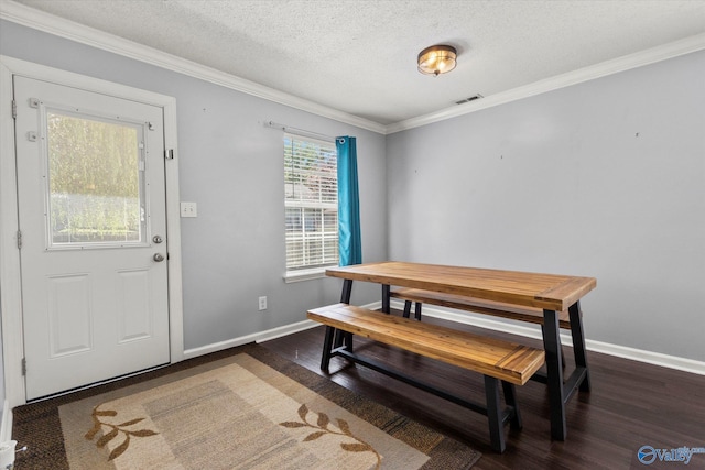 dining space featuring dark wood-style flooring, crown molding, and baseboards