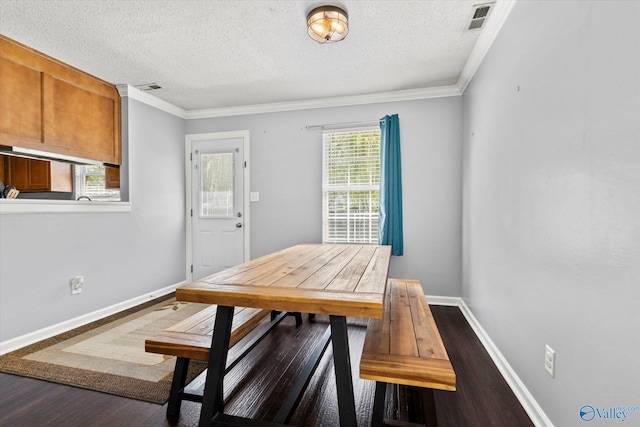 dining space with visible vents, crown molding, baseboards, and wood finished floors