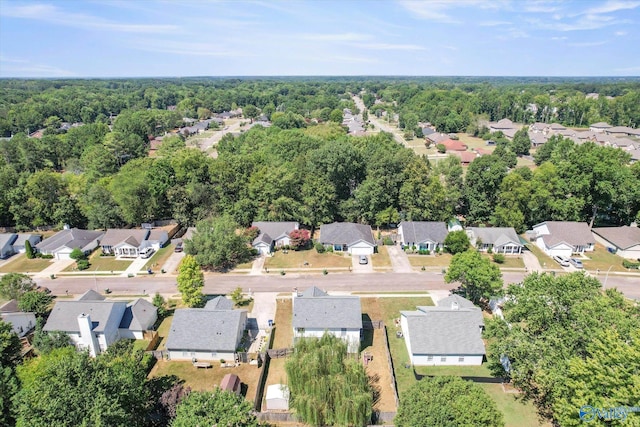 birds eye view of property featuring a forest view and a residential view