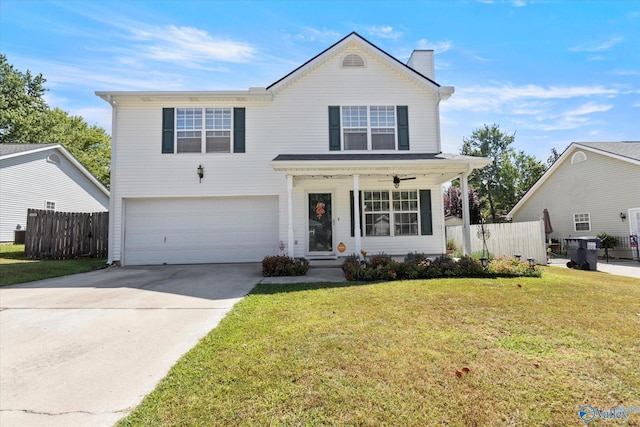 traditional home featuring an attached garage, covered porch, fence, driveway, and a front lawn