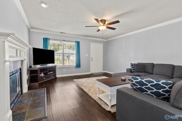 living room with ceiling fan, dark wood-style flooring, a premium fireplace, baseboards, and ornamental molding