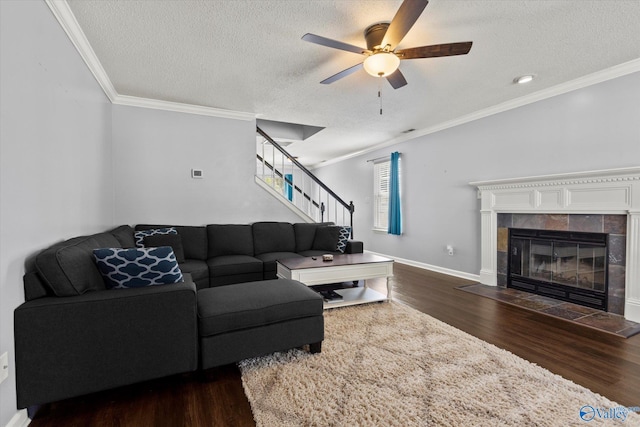 living area featuring stairs, ornamental molding, and wood finished floors