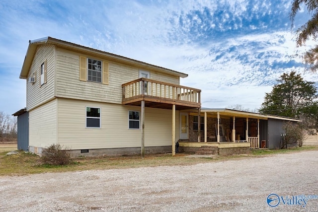 back of property featuring a balcony