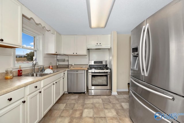 kitchen featuring white cabinetry, sink, a textured ceiling, and appliances with stainless steel finishes