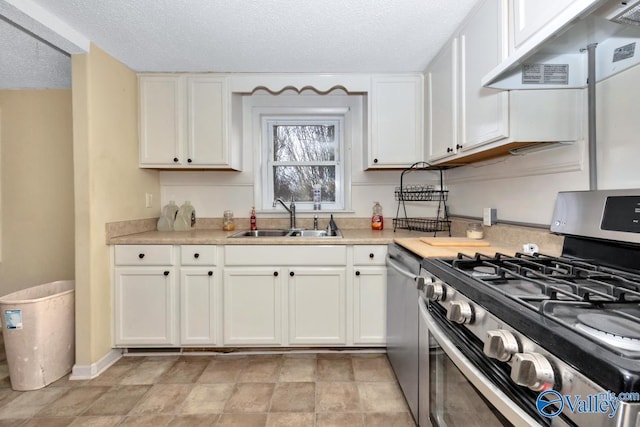 kitchen with appliances with stainless steel finishes, extractor fan, sink, and white cabinets