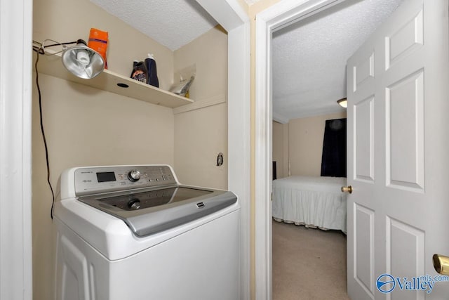 washroom featuring washer / dryer, a textured ceiling, and carpet flooring