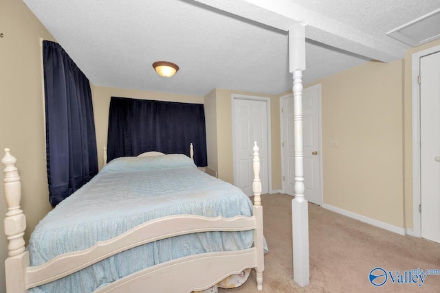 carpeted bedroom featuring a textured ceiling