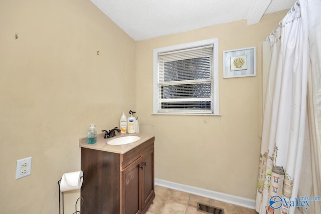 bathroom featuring vanity and a textured ceiling