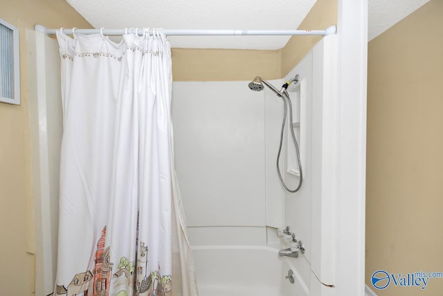 bathroom featuring a textured ceiling and shower / bath combo with shower curtain