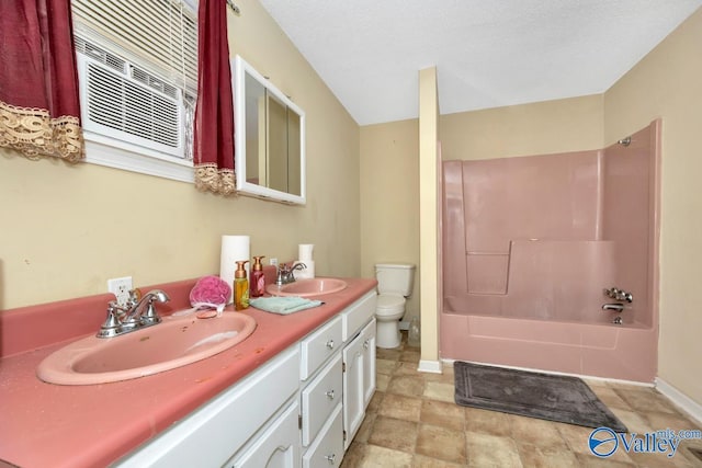 full bathroom with vanity, tub / shower combination, a textured ceiling, and toilet