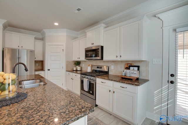 kitchen featuring visible vents, appliances with stainless steel finishes, white cabinets, and a sink