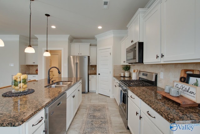 kitchen featuring stainless steel appliances, a sink, white cabinets, backsplash, and crown molding