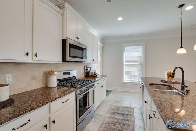 kitchen with stainless steel appliances, backsplash, a sink, and crown molding