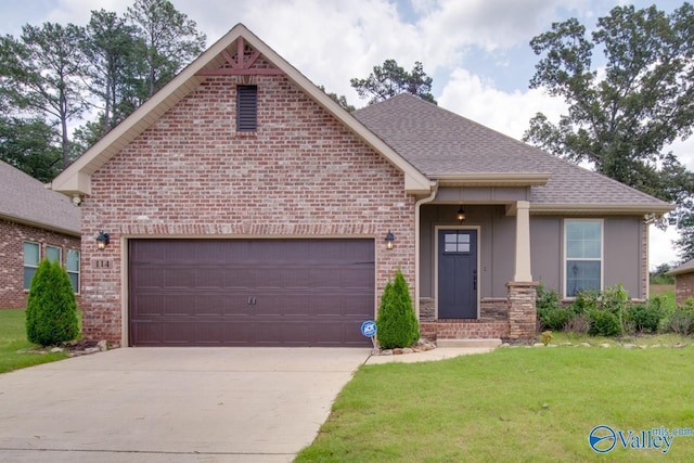 view of front of property featuring a garage, brick siding, driveway, roof with shingles, and a front yard