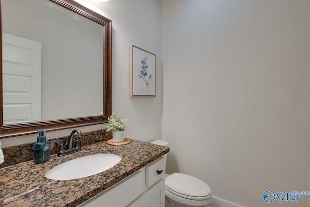 bathroom featuring toilet and vanity