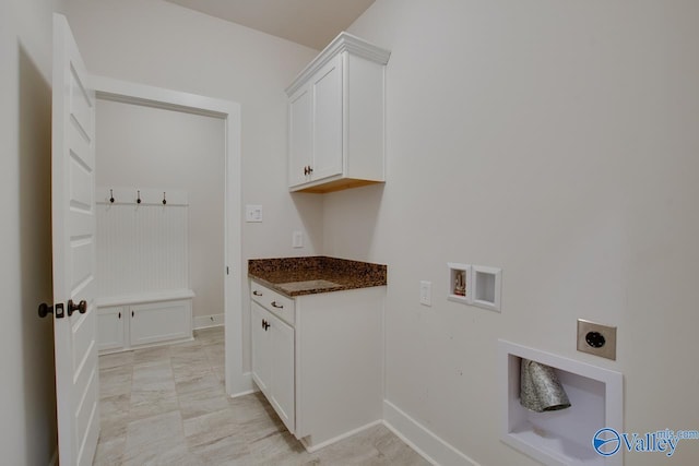 clothes washing area featuring washer hookup, cabinet space, electric dryer hookup, and baseboards