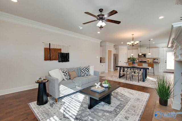 living room featuring light wood-style floors, baseboards, crown molding, and ceiling fan with notable chandelier