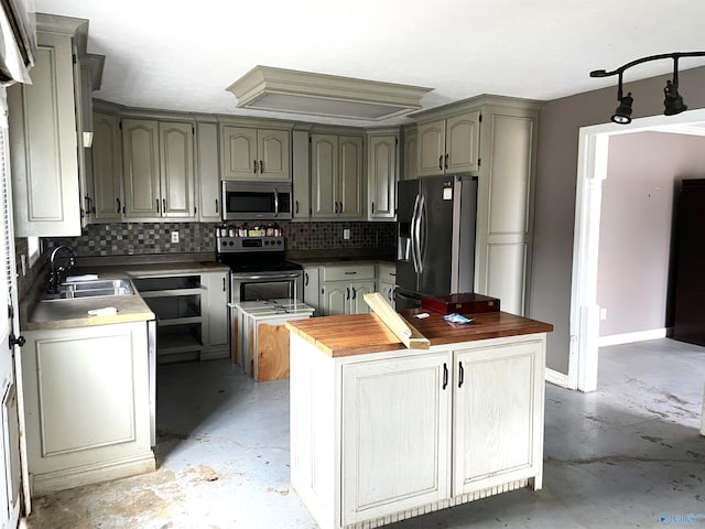 kitchen featuring tasteful backsplash, stainless steel appliances, sink, and butcher block countertops