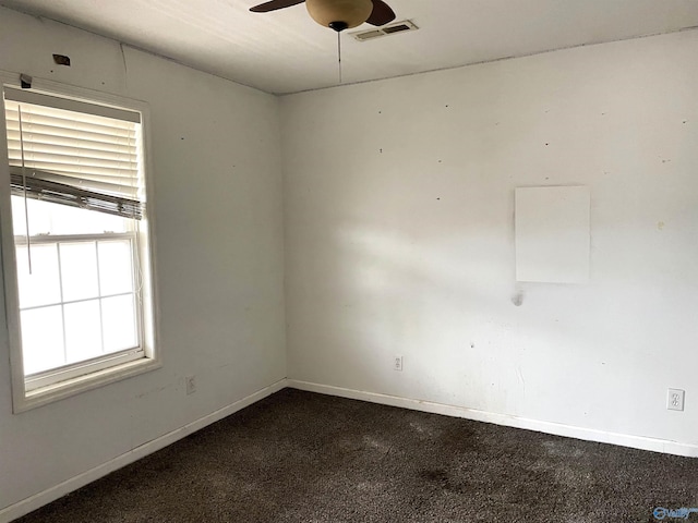 unfurnished room featuring ceiling fan and dark colored carpet