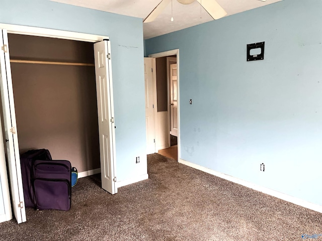 unfurnished bedroom featuring a closet, ceiling fan, and dark colored carpet