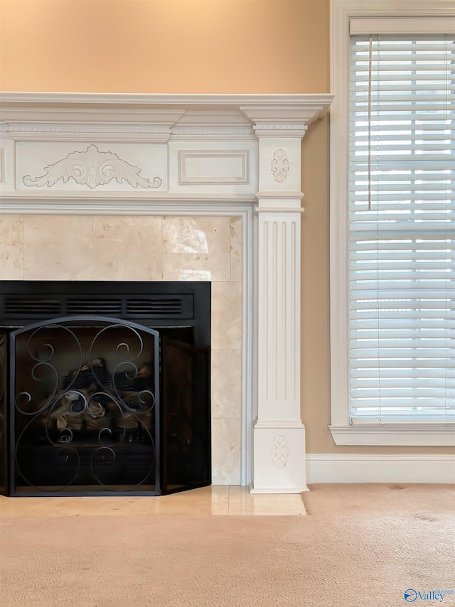 interior details featuring carpet flooring, a fireplace, and baseboards