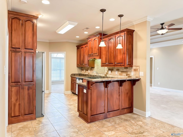 kitchen featuring backsplash, crown molding, a breakfast bar, appliances with stainless steel finishes, and a peninsula