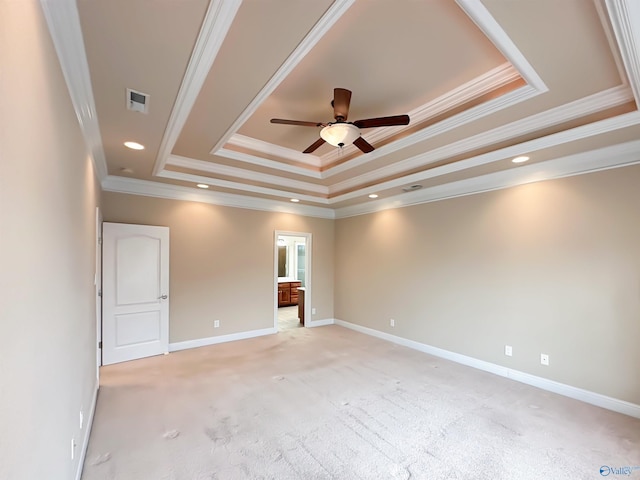 empty room featuring light carpet, a raised ceiling, a ceiling fan, recessed lighting, and baseboards