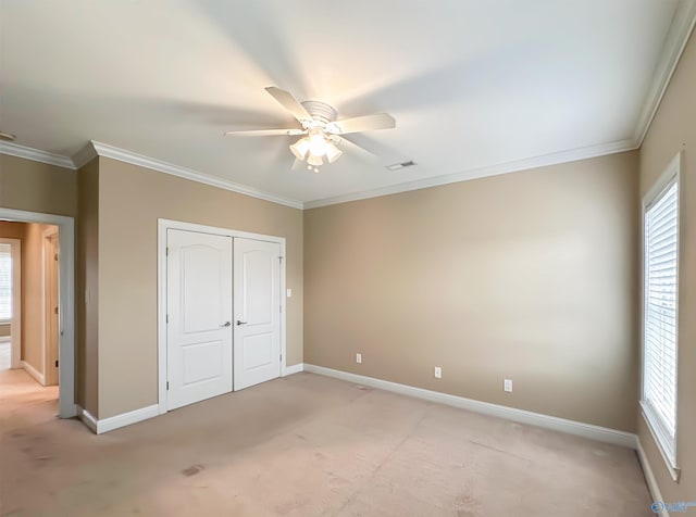 unfurnished bedroom with light carpet, baseboards, a closet, and ornamental molding