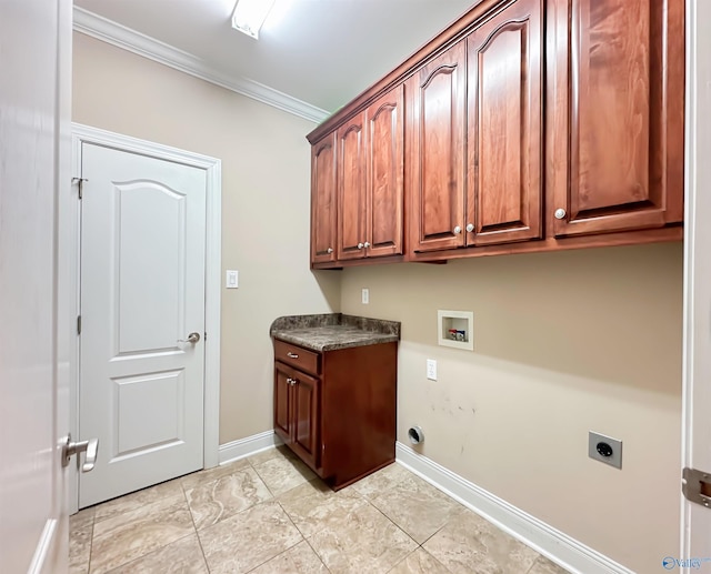 clothes washing area featuring baseboards, hookup for an electric dryer, cabinet space, washer hookup, and crown molding