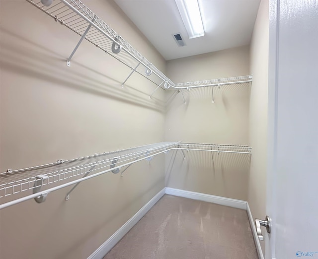 spacious closet with visible vents and carpet