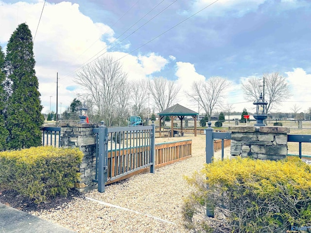 view of gate featuring a gazebo and fence