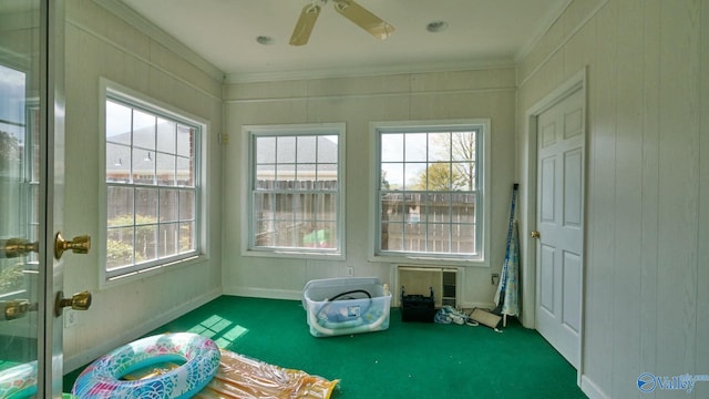 unfurnished sunroom with ceiling fan