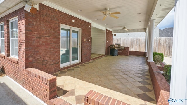 view of patio / terrace featuring fence and a ceiling fan