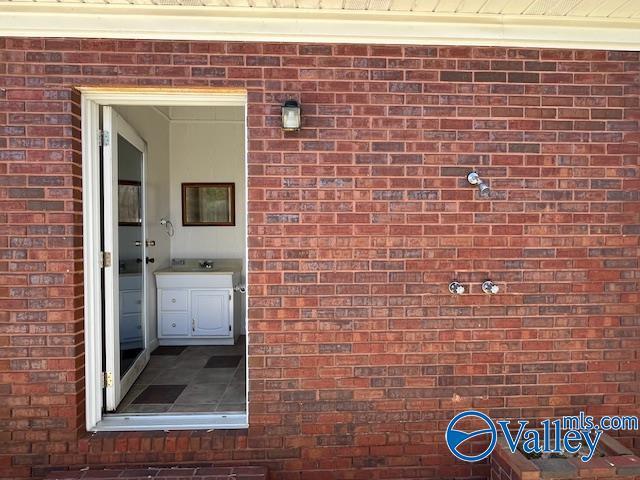 property entrance with brick siding