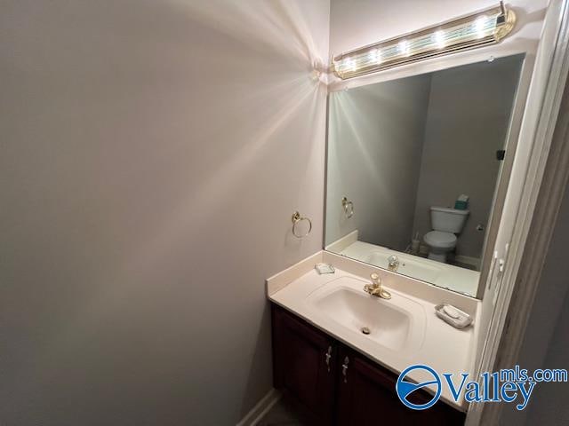 bathroom with vanity and toilet