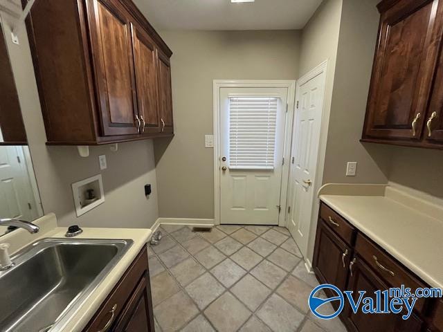 laundry room featuring light tile patterned flooring, sink, electric dryer hookup, cabinets, and washer hookup