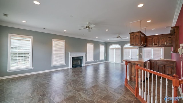 living area featuring baseboards, a ceiling fan, visible vents, and ornamental molding