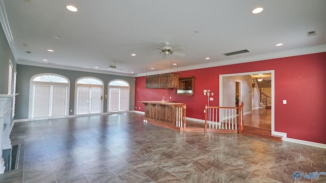 unfurnished living room with visible vents, a fireplace, and crown molding