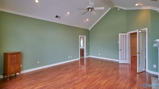 unfurnished bedroom with wood-type flooring, ensuite bathroom, high vaulted ceiling, and ornamental molding