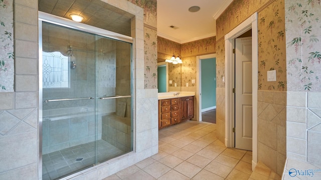 full bath featuring wallpapered walls, a shower stall, tile patterned flooring, vanity, and ornamental molding