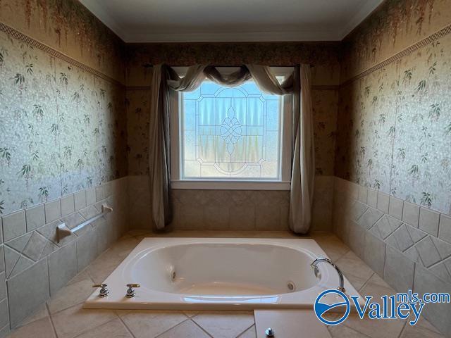 bathroom featuring wallpapered walls, a jetted tub, and a wealth of natural light