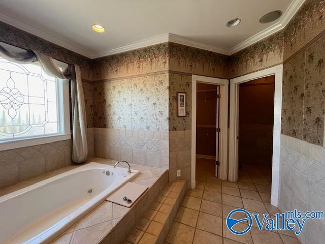 bathroom with a relaxing tiled tub, tile patterned flooring, and ornamental molding