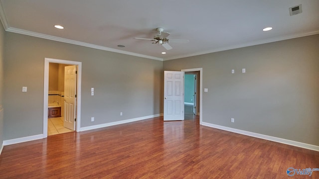 unfurnished bedroom featuring ornamental molding, ensuite bath, light tile patterned floors, and ceiling fan