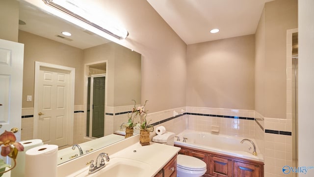 bathroom with vanity, a bath, and toilet