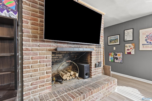 details featuring a brick fireplace and hardwood / wood-style flooring