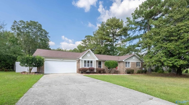 165 S Hawk Dr, Rainbow City, AL 35906 - single story home featuring brick siding, an attached garage, concrete driveway, and a front lawn