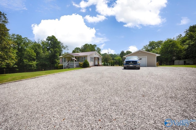215 Dusty Dr SW, Arab, AL 35016 - single story home with an outdoor structure, gravel driveway, a garage, and covered porch