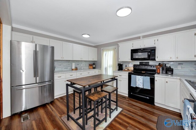 215 Dusty Dr SW, Arab, AL 35016 - kitchen featuring black appliances, decorative backsplash, light countertops, and white cabinets