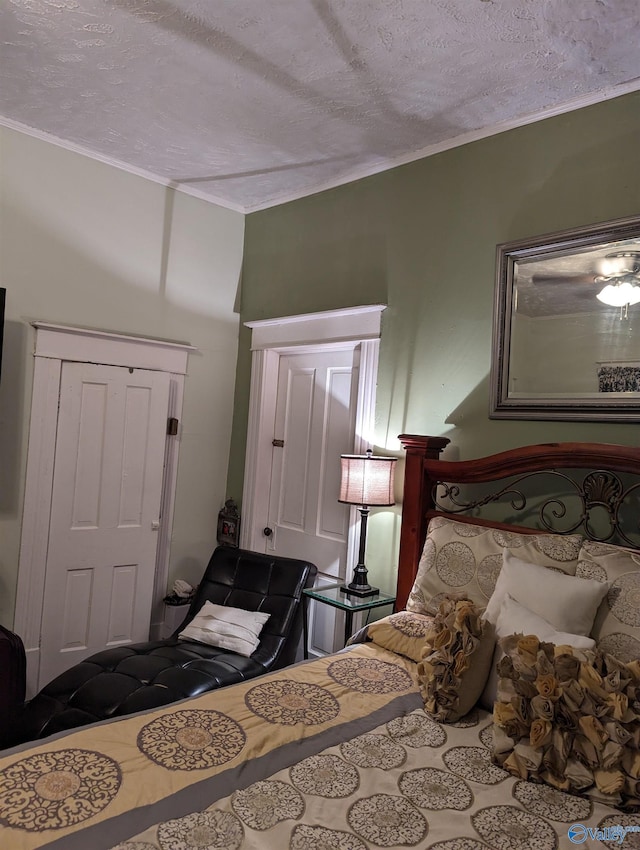 bedroom featuring ornamental molding and a textured ceiling