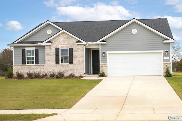 view of front of property featuring a garage and a front yard